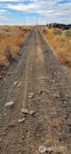 Road along west boundary line of property