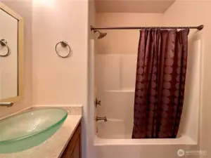 The second main floor bedroom has its own full bath.