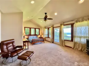 The upper primary bedroom has a deck, large walk-in closet, fireplace & full ensuite with jetted tub.