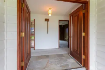 Double doors leading into home with stone entry