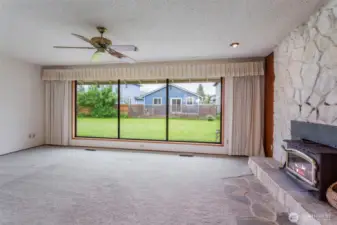 Gorgeous wall of windows, stone fireplace in living room