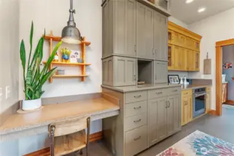 Thoughtful coffee nook and additional custom storage elevate both function and charm in the kitchen.