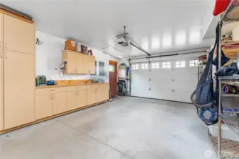 Second garage bay features custom built-ins, a Phase 2 EV charger, and a dedicated dog grooming tub—designed for convenience and modern living.