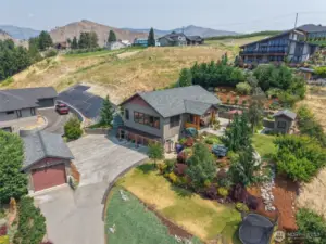 Overhead view captures the full property and its scenic surroundings—showcasing layout, landscaping, and natural beauty.