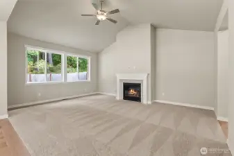 Lovely, vaulted ceilings in living room. Ceiling fans are standard in living rooms and primary bedroom
