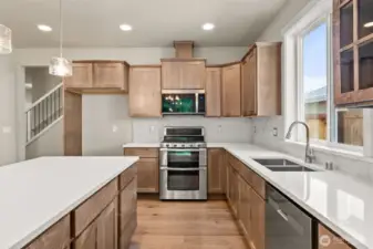 Plenty of storage in these beautiful maple cabinets.
