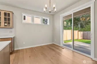 Dining nook area and sliding door leading to backyard.
