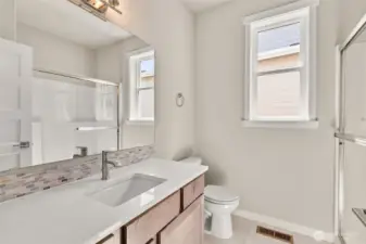 3/4 bathroom adjacent to bed#1. Quartz countertop with undermounted square sink.
