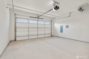 Double car garage is drywalled and includes garage door opener.