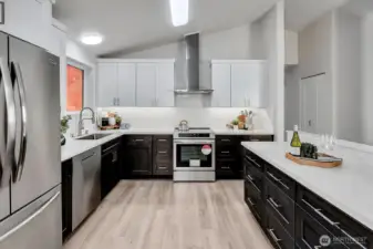 Cabinet height solid quartz backsplash with under cabinet lighting.