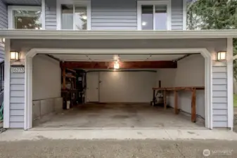 Garage finished and painted w/ new electrical panel, work benches and wired for EV charger,