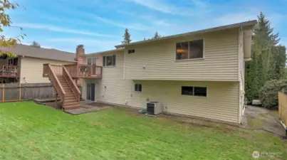 Seamless indoor-outdoor living with upper deck access and a spacious backyard below