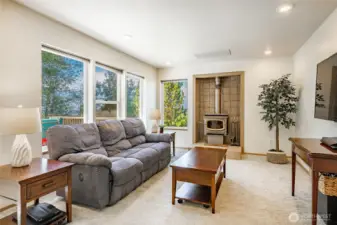 Family Room off kitchen has a cozy fireplace and lots of natural light