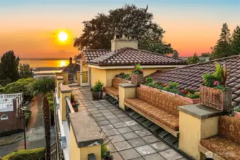 Expansive rooftop deck extends along the south side of house with planter gardens, built-in seating, and breathtaking views of the Seattle city skyline, the Space Needle, Elliott Bay, Mount Rainier, and the Olympic mountain range.