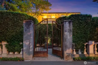 The ornate, wrought-iron gated entry creates a dramatic entrance on West Highland Drive.