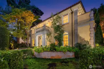 An absolutely stunning home day or night – wall lanterns and landscape lighting create a gorgeous twilight exterior.
