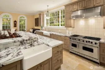 This delightful epicurean kitchen features stunning marble countertops, Shaws fireclay kitchen sinks, and high-end appliances, including a Viking Professional 6-burner gas range with griddle and double oven, a Viking Professional built-in single electric wall oven, a Sub-Zero built-in refrigerator and freezer, and two Bosch dishwashers.