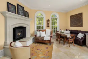 Wonderful breakfast area and fireside sitting area with custom limestone gas fireplace. The tall classic windows overlook the north gardens.