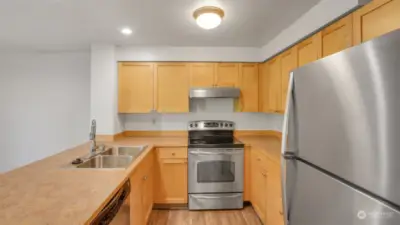 The galley style kitchen is perfectly situated in the unit boasting neutral toned cabinetry & tons of storage.