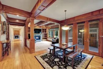 View from kitchen to breakfast nook and  informal living room with den down the hallway. Warm wood accents thru out this home lend to a comforting feeling.