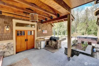 Covered BBQ area leading to the outdoor cabana for relaxation or entertaining.