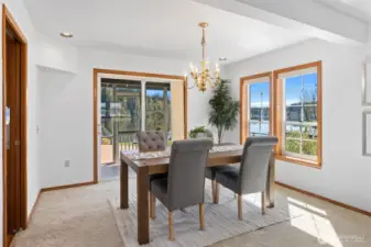 Formal dining room with slider opening up to one of two screened in porches.
