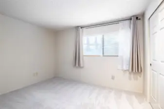 Second bedroom. Faces the front. Featuring fresh new carpet.