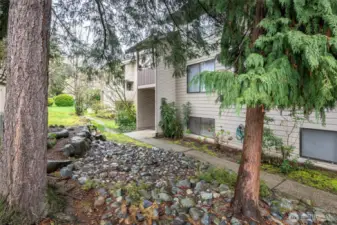 Beautifully landscaped grounds. To the right you can see the paved walkway to your unit.