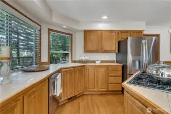 Large windows in the kitchen offer stunning views of the beautiful backyard, flooding the space with natural light. It's the perfect spot to enjoy the scenery while cooking or relaxing.