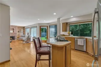 The spacious kitchen and expansive gathering area offer direct access to the beautiful backyard, perfect for indoor-outdoor living. This seamless connection makes entertaining effortless and enjoyable.