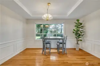 The large dining room bay window offers the perfect view of the outdoors, filling the space with natural light. It creates a bright and inviting atmosphere for every meal.