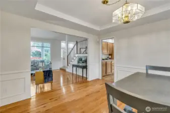 The dining room features a discreet pocket door that leads seamlessly into the kitchen, combining style with functionality. It's a thoughtful detail that enhances flow while maintaining the room’s formal charm.