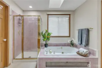 The primary full bath boasts a large jetted tub offers a space to unwind and relax. It’s the perfect retreat for a soothing soak after a long day.