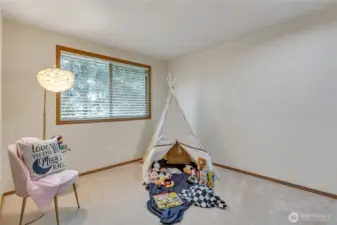The third bedroom on the second level is spacious, features a large closet, and is tucked away for added privacy. It’s a quiet, cozy retreat perfect for rest or relaxation.