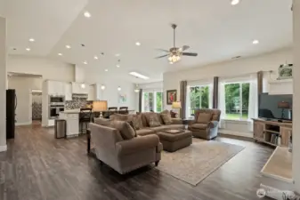 From the living area in the great room looking towards the kitchen. Take note of the skylight.  Big windows and skylight add to all of the natural light!