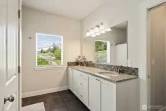 Primary bath with tall vanity, double sinks, and separate water closet.