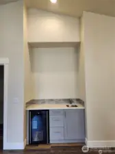 Bar off kitchen with beverage cooler and sink