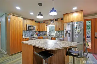 The kitchen has been remodeled to include an island with eating space.