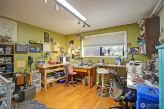 One of the bedrooms is being used as a craft room for hobbies.