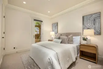 Second bedroom with a door to the side garden.