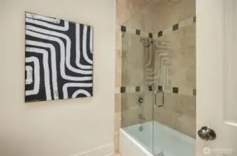 Full bathroom with a tub and shower.
