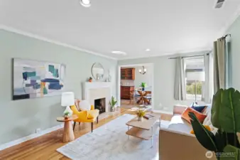 Bright and open living room with wood burning fireplace.