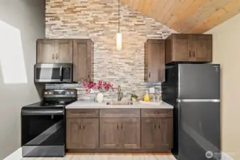 Appliances stay! Also features a full stone wall and cabinet lighting.