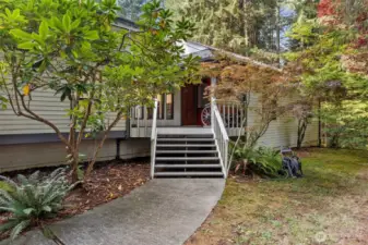 Entrance with mature landscaping.