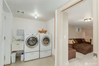 Laundry room with exterior door to stairway up to back yard.