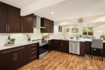 The kitchen is spacious with an induction range and Bosch dishwasher (both new 2023). In above cabinet, left of stove, you will find a pull-out spice rack, very convenient for all!