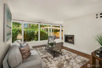 Cozy living room with double sided wood burning fireplace. The other side is in the dining room off kitchen.