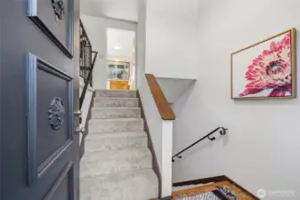 Welcoming entry landing creates a natural transition between levels, enhanced by brand-new carpet for a fresh, inviting feel.