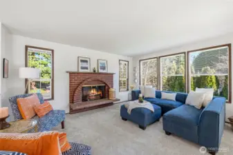 Warm and inviting living room anchored by a timeless brick wood-burning fireplace.