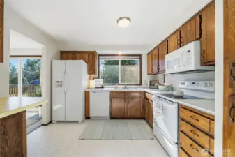 Spacious kitchen featuring abundant cabinetry, generous storage, and new vinyl flooring.